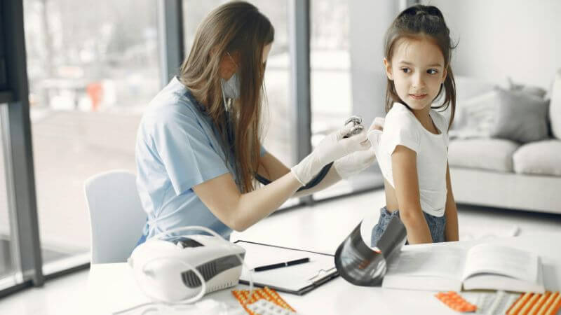 Young girl in clinic receiving a checkup.